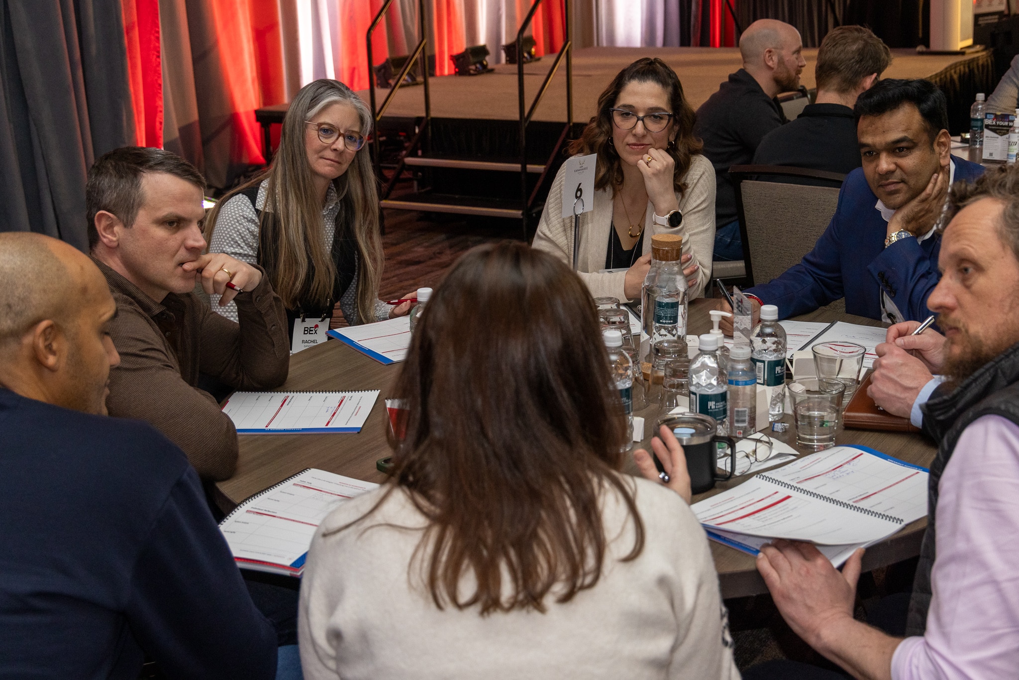 Engaged group listening intently at breakout session table