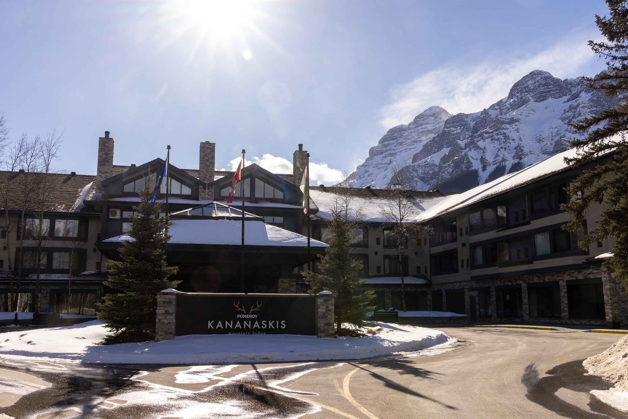 Pomeroy Kananaskis Mountain Lodge at dusk with moon rising over the mountains