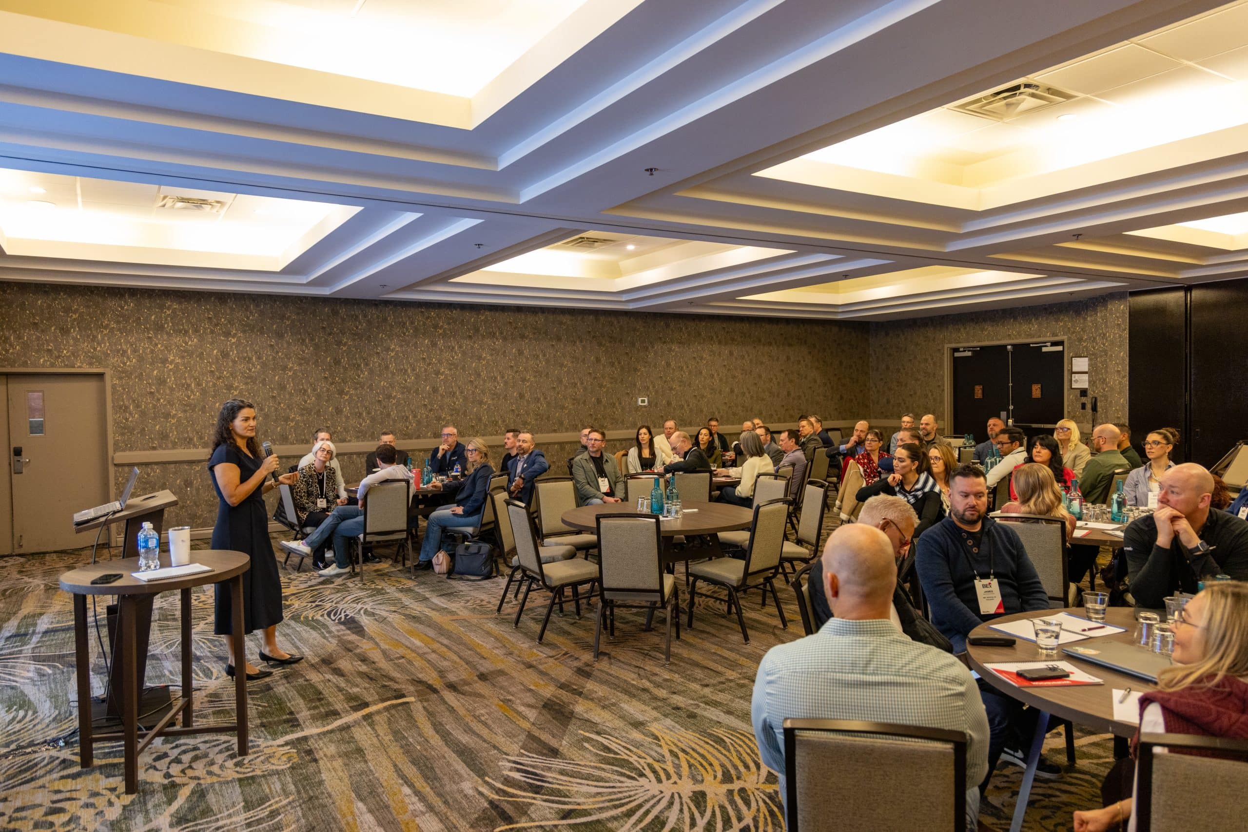 Small group in focused discussion at round table during BEx Connex session