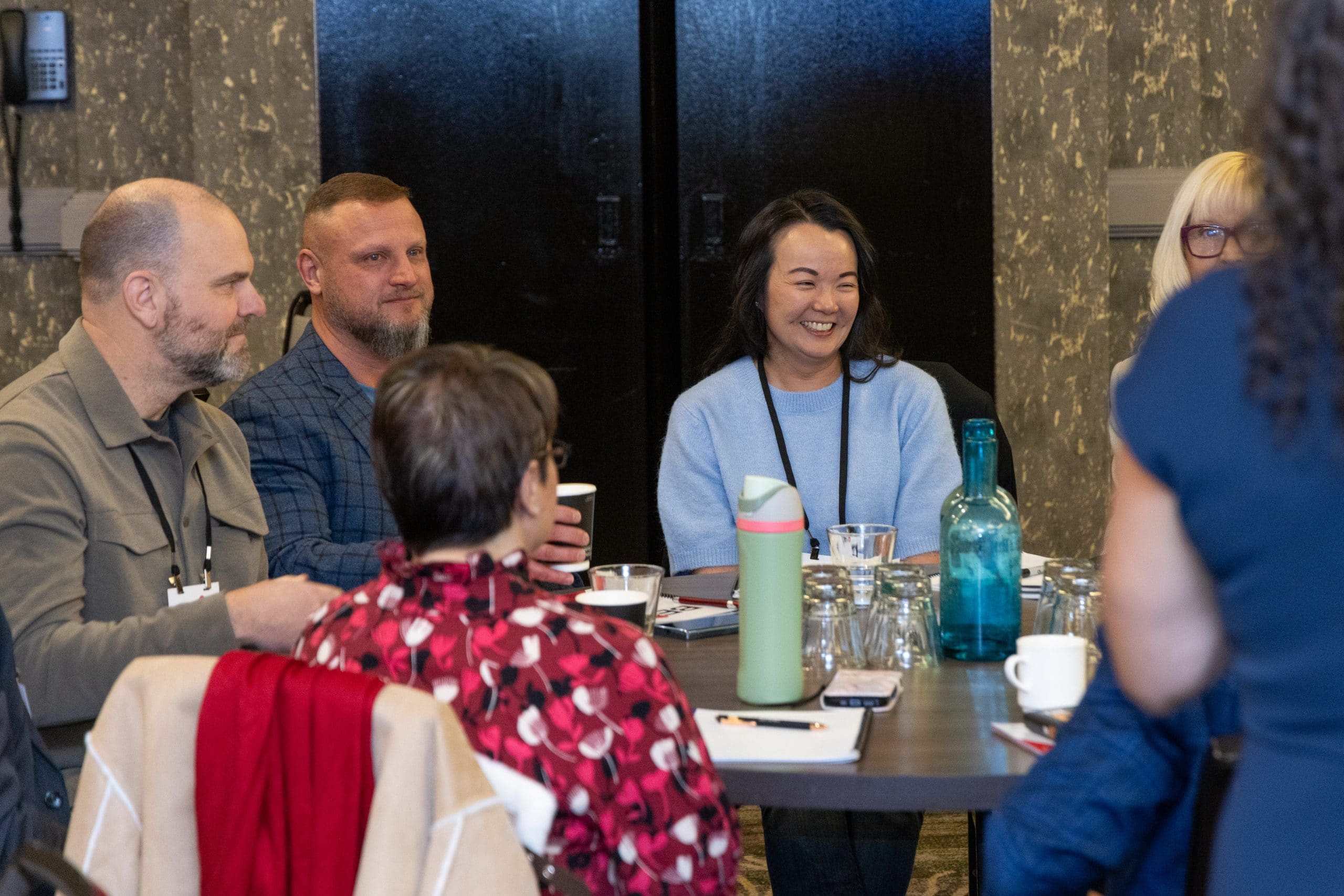 Small group in animated discussion during final Tuesday breakout session