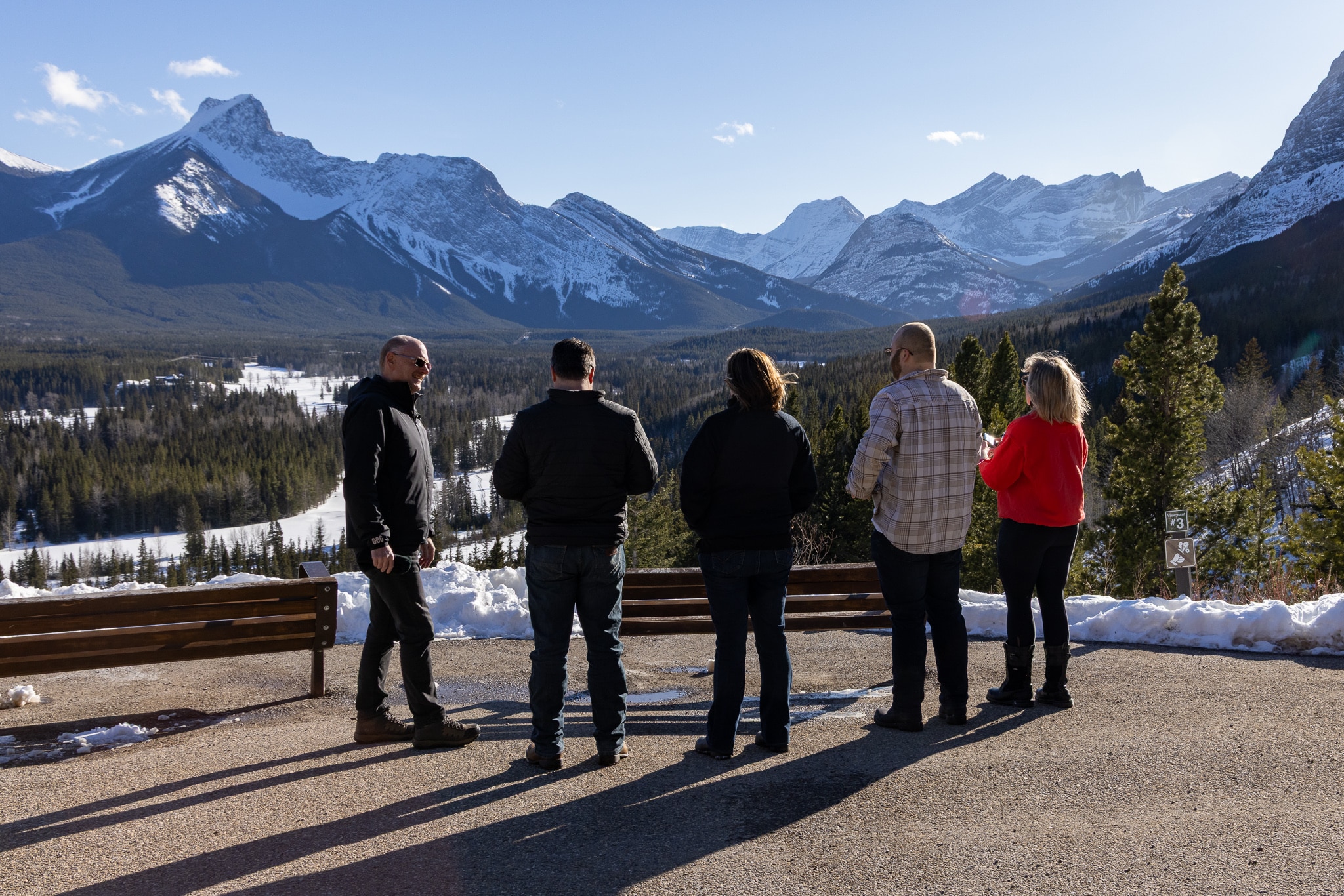 Five BEx attendees standing at mountain overlook with sweeping Kananaskis valley view