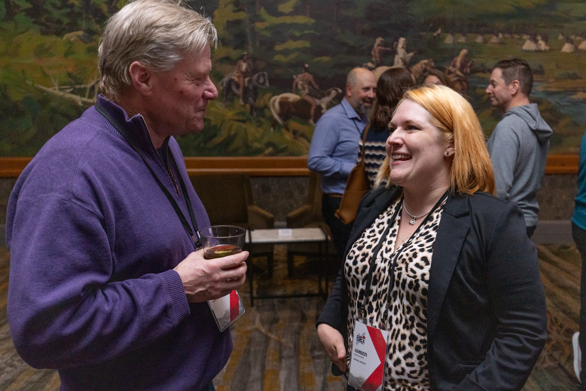 Two BEx attendees in warm candid conversation at welcome reception