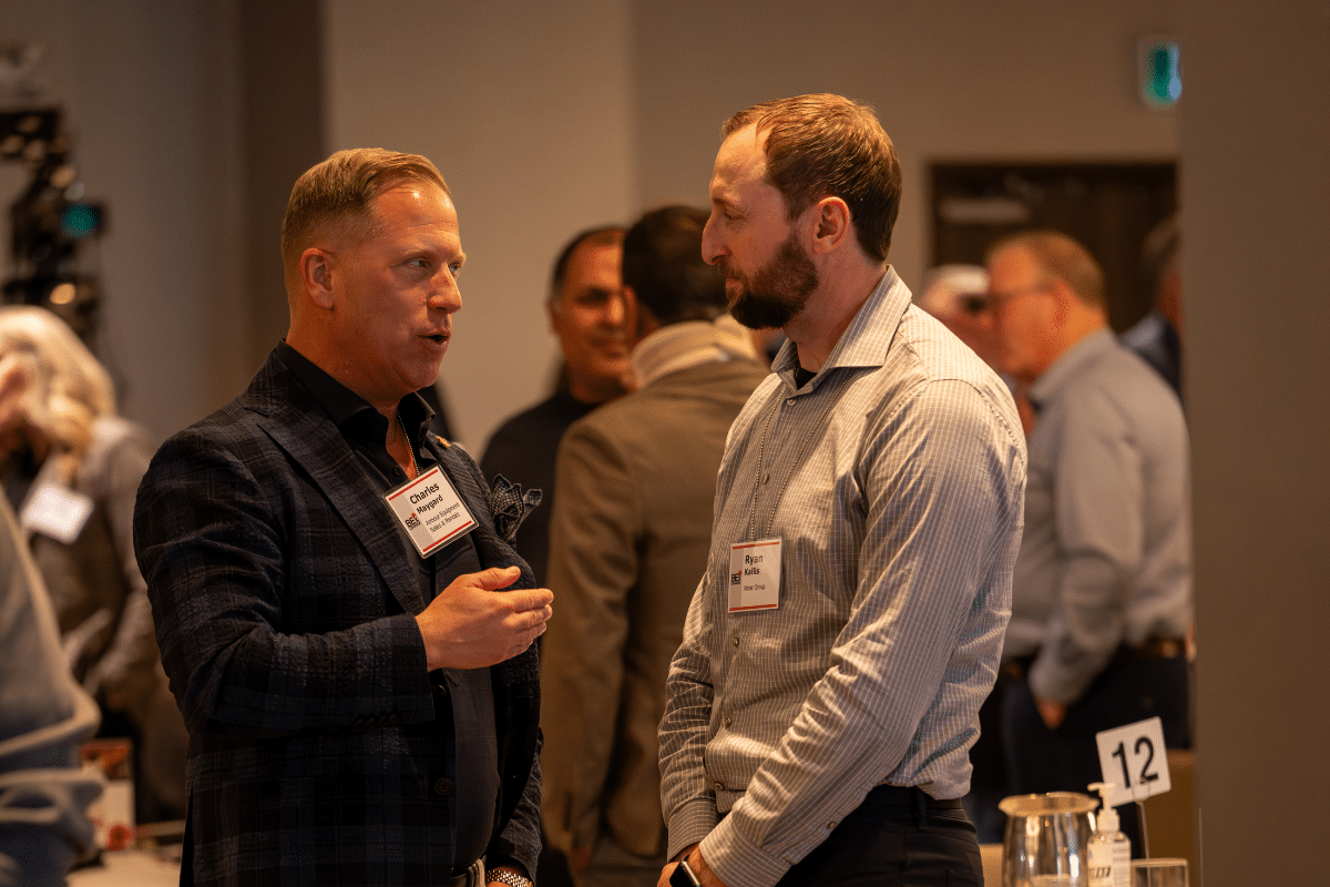 Connex attendees in deep conversation during break